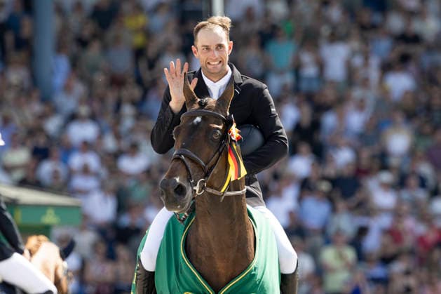 Richard VOGEL GER on United Touch S, apologizes for knocking over the Rolex Cup, single picture, at the award ceremony, Jumping S6 ROLEX Grand Prix, Part of the ROLEX Grand Slam of Show Jumping, The Grand Prix of Aachen, Jumping competition with two rounds and jump-off, CSI5, on 24 05 2026, World Equestrian Festival, TSCHIO Aachen 2026 from 22 24 05 2026 in Aachen Germany Â
