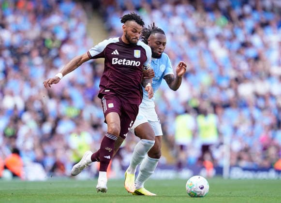 Manchester, England, 24th May 2026. Tyrone Mings of Aston Villa tussles with Antoine Semenyo of Manchester City during the Manchester City vs Aston Villa Premier League match at the Etihad Stadium, Manchester. Picture credit should read: Andrew Yates Sportimage EDITORIAL USE ONLY. No use with unauthorised audio, video, data, fixture lists, club league logos or live services. Online in-match use limited to 120 images, no video emulation. No use in betting, games or single club league player publications. SPI_036_AY_Man_City_Villa SPI-4819-0041