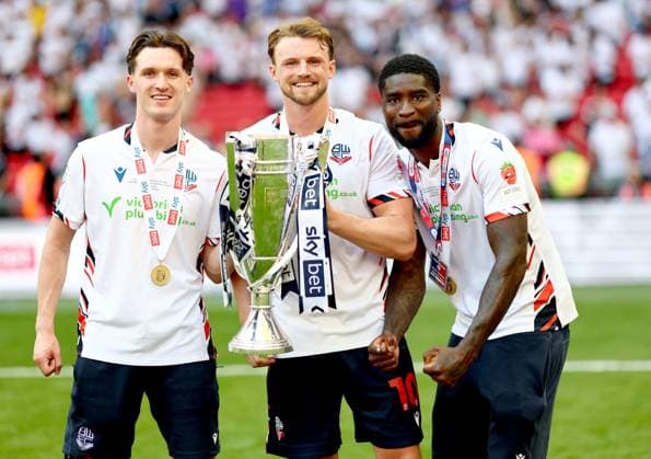 (Left to right) Josh Sheehan, Sam Dalby and Jordi Osei-Tutu of Bolton Wanderers celebrate after winning the Sky Bet EFL League One Play-off Final and promotion to the Sky Bet EFL Championship Bolton Wanderers v Stockport County, EFL Sky Bet League One, Play-Off Final, Football, Wembley Stadium, London, UK - 24 May 2026London Wembley Stadium United Kingdom EDITORIAL USE ONLY No use with unauthorised audio, video, data, fixture lists, club league logos or live services. Online in-match use limited to 120 images, no video emulation. No use in betting, games or single club league player publications.  Copyright: xSimonxDael Shutterstockx 16889811il
