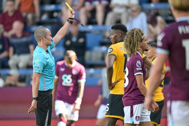 24th May 2026; Turf Moor, Burnley, Lancashire, England; Premier League Football, Burnley versus Wolverhampton Wanderers; match referee Andrew Kitchen shows Hannibal Mejbri of Burnley the yellow card LeexDurkin