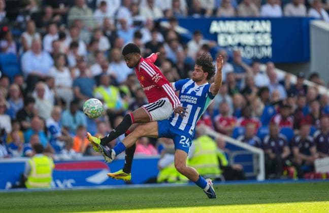 Amad Diallo of Manchester United, ManU and Ferdi Kadioglu of Brighton battle for the ball. Brighton and Hove Albion v Manchester United, Premier League, Football, American Express Community Stadium, Brighton, UK - 24 May 2026Brighton American Express Community Stadi United Kingdom EDITORIAL USE ONLY No use with unauthorised audio, video, data, fixture lists, club league logos or live services. Online in-match use limited to 120 images, no video emulation. No use in betting, games or single club league player publications.  Copyright: xSeanxRyan Shutterstockx 16889822ay