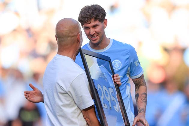 Manchester City v Aston Villa, Premier League John Stones (5) of Manchester City receives a commemorative shirt from Pep Guardiola the Manchester City manager during the celebrations at the end of the Premier League match between Manchester City and Aston Villa at the Etihad Stadium, Manchester, UK on 24 May 2026. Manchester Etihad Stadium Manchester UK Editorial use only DataCo restrictions apply See www.football-dataco.com , Copyright: xConorxMolloyx PSI-24291-0051