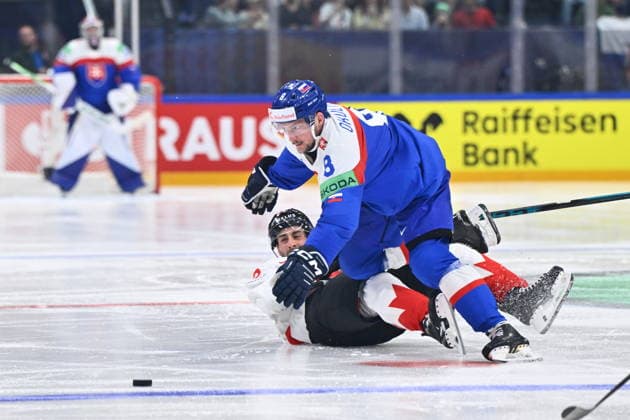 L-R Oliver Okuliar (SVK) and Evan Bouchard (CAN) in action during to the group B match of the World Ice hockey, Eishockey Championship, Slovakia - Canada, Fribourg, Switzerland, on May 24, 2026. (CTKxPhoto RadekxPetrasek) CTKPhotoP2026052407003  CTKPhotoP2026052407003