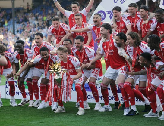 Football - 2025 2026 Premier League - Crystal Palace vs. Arsenal - Selhurst Park - Sunday 24th May 2026 Martin Odegaard of Arsenal leads the celebrations with the team and trophy 