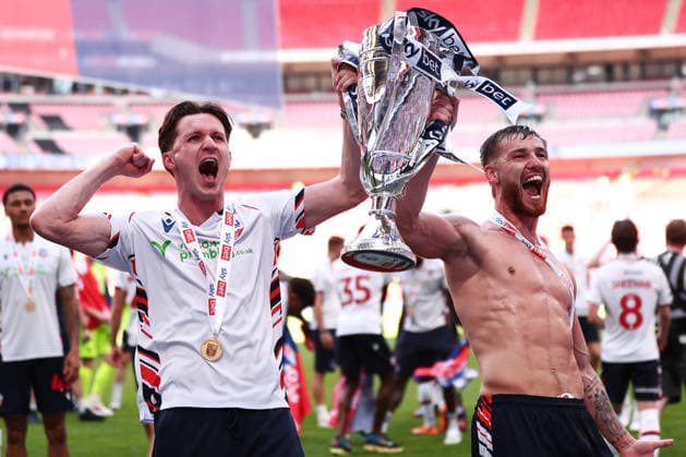 London, England, 24th May 2026. Johnny Kenny of Bolton Wanderers and John McAtee of Bolton Wanderers lift the trophy following victory during the Bolton Wanderers vs Stockport County Sky Bet League 1 play off final match at Wembley Stadium, London. Picture credit should read: Jake Youle Sportimage EDITORIAL USE ONLY. No use with unauthorised audio, video, data, fixture lists, club league logos or live services. Online in-match use limited to 120 images, no video emulation. No use in betting, games or single club league player publications. SPI_059_JY_Stockport_County_Bolton_Wanderers SPI-4821-0059