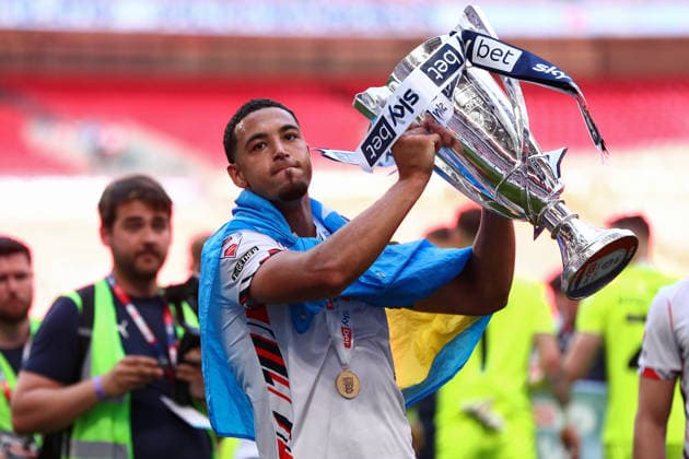 London, England, 24th May 2026. Chris Forino-Joseph of Bolton Wanderers lifts the trophy following victory during the Bolton Wanderers vs Stockport County Sky Bet League 1 play off final match at Wembley Stadium, London. Picture credit should read: Jake Youle Sportimage EDITORIAL USE ONLY. No use with unauthorised audio, video, data, fixture lists, club league logos or live services. Online in-match use limited to 120 images, no video emulation. No use in betting, games or single club league player publications. SPI_063_JY_Stockport_County_Bolton_Wanderers SPI-4821-0063