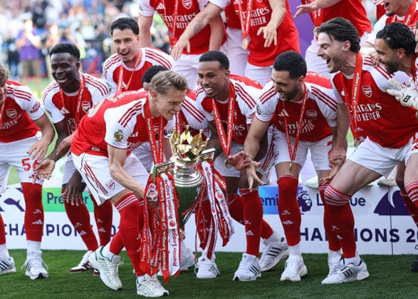 Crystal Palace gegen Arsenal 24. Mai 2026, London Premier League Fußball Crystal Palace gegen Arsenal Martin Odegaard von Arsenal geht mit der Premier League-Trophäe an seinen Mannschaftskameraden vorbei, bevor er sie in die Höhe stemmt Foto Jacques Feeney Abseits London UK  Copyright: xJacquesxFeeneyx xOffsidexOffside