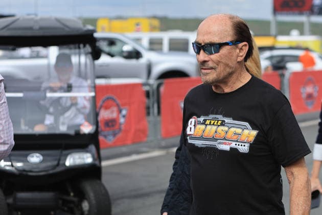 CHARLOTTE, NC - MAY 24: Lee Greenwood walks in the garage area wearing a t-shirt honoring the late Kyle Busch prior to the running of the NASCAR, Motorsport, USA Cup Series Coca-Cola 600 on May 24, 2026 at Charlotte Motor Speedway in Charlotte, NC. (Photo by Jeff Robinson Icon Sportswire) AUTO: MAY 24 NASCAR Cup Series Coca-Cola 600 EDITORIAL USE ONLY Icon2605246542600