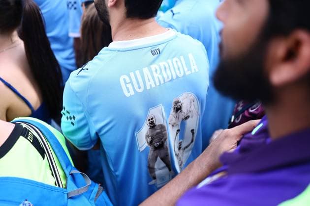 A fan with a Pep Guardiola City shirt Manchester City Carabao Cup and FA Cup trophy Parade, Premier League, Football, Manchester, UK - 25 May 2026Manchester United Kingdom EDITORIAL USE ONLY No use with unauthorised audio, video, data, fixture lists, club league logos or live services. Online in-match use limited to 120 images, no video emulation. No use in betting, games or single club league player publications.  Copyright: xPhilxOldham Shutterstockx 16889909l