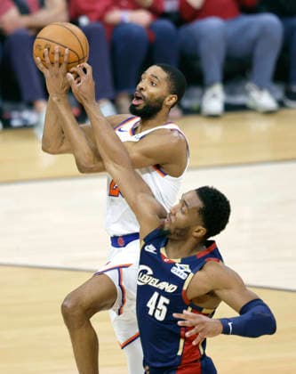 New York Knicks Mikal Bridges (25) shoots over Cleveland Cavaliers Donovan Mitchell (45) in the first quarter of the Eastern Conference Final game 4 in Cleveland, Ohio Monday May 25, 2026.  CLE20260525102 AARONxJOSEFCZYK