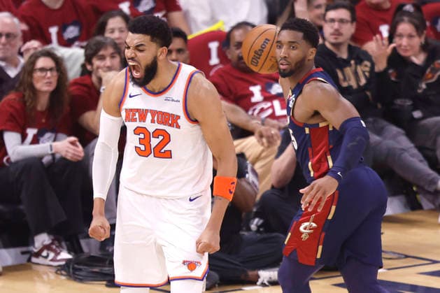 New York Knicks Karl-Anthony Towns (32) reacts after a dunk in front of Cleveland Cavaliers Donovan Mitchell (45) in the second quarter of the Eastern Conference Final game 4 in Cleveland, Ohio Monday May 25, 2026.  CLE20260525109 AARONxJOSEFCZYK