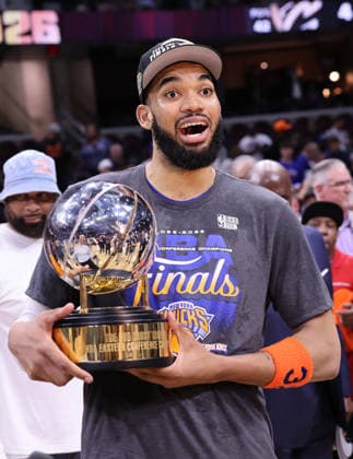 The New York Knicks Karl-Anthony Towns holds the Eastern Conference Trophy after defeating the Cleveland Cavaliers 130-93 to win the series 4-0 in Cleveland, Ohio Monday May 25, 2026.  CLE20260525116 AARONxJOSEFCZYK