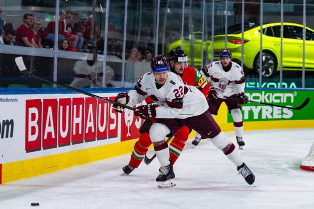 ZURICH, SWITZERLAND - MAY 26: Toms Andersons (Latvia, 22) in the battle for the puck with Tamas Ortenszky (Hungary, 55) during the Preliminary Round - Group A Match 51 between Hungary and Latvia at the IIHF Ice hockey, Eishockey World Championship, WM, Weltmeisterschaft 2026, Swiss Life Arena on May 26, 2026 in Zurich, Switzerland. Zurich Switzerland Copyright: xTimoxSteinx