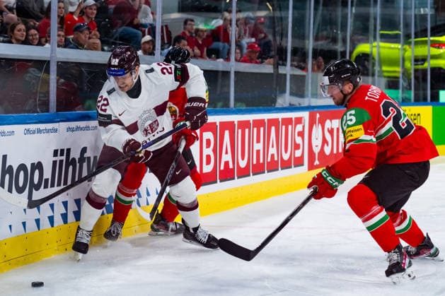 ZURICH, SWITZERLAND - MAY 26: Toms Andersons (Latvia, 22) in the battle for the puck with Gabor Tornyai (Hungary, 25) during the Preliminary Round - Group A Match 51 between Hungary and Latvia at the IIHF Ice hockey, Eishockey World Championship, WM, Weltmeisterschaft 2026, Swiss Life Arena on May 26, 2026 in Zurich, Switzerland. Zurich Switzerland Copyright: xTimoxSteinx