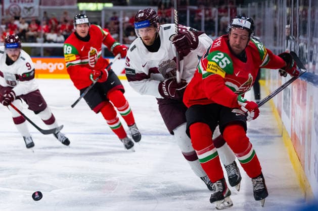 ZURICH, SWITZERLAND - MAY 26: Gabor Tornyai (Hungary, 25) in the battle for the puck with Oskars Batna (Latvia, 95) during the Preliminary Round - Group A Match 51 between Hungary and Latvia at the IIHF Ice hockey, Eishockey World Championship, WM, Weltmeisterschaft 2026, Swiss Life Arena on May 26, 2026 in Zurich, Switzerland. Zurich Switzerland Copyright: xTimoxSteinx