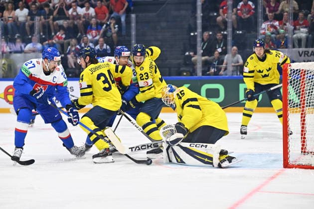 From left Marek Hrivik of Slovakia, Albert Johansson of Sweden and goalkeeper Albert Johansson of Sweden in action during the IIHF World Championship, WM, Weltmeisterschaft Group B match Sweden vs Slovakia on May 26, 2026, Fribourg, Switzerland. (CTKxPhoto RadekxPetrasek) CTKPhotoP2026052606302  CTKPhotoP2026052606302