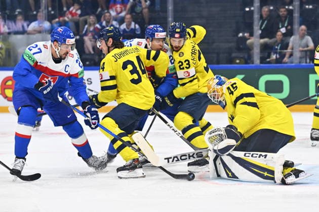 From left Marek Hrivik of Slovakia, Albert Johansson of Sweden and goalkeeper Albert Johansson of Sweden in action during the IIHF World Championship, WM, Weltmeisterschaft Group B match Sweden vs Slovakia on May 26, 2026, Fribourg, Switzerland. (CTKxPhoto RadekxPetrasek) CTKPhotoP2026052606349  CTKPhotoP2026052606349