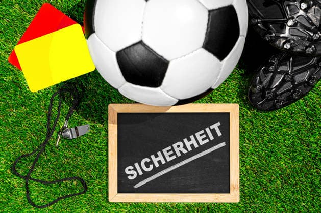 Germany - May 22, 2026: PHOTO MONTAGE: Soccer cleats, a ball, and referee gear symbolize security concepts for the 2026 World Cup and highlight measures to protect players, fans, and events. *** FOTOMONTAGE, Fußballschuhe, Ball und Schiedsrichterausrüstung symbolisieren Sicherheitskonzepte bei der WM 2026 und verdeutlichen Maßnahmen zum Schutz von Spielern, Fans und Veranstaltungen.
