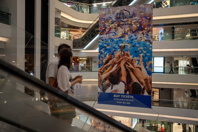 HONGKONG-SOCCER FIFA-MUSEUM People riding on escalators pass a large banner for the FIFA Museum Hong Kong inside a shopping mall in Hong Kong, May 28, 2026. NEXPHER Vernon Yuen HONG KONG