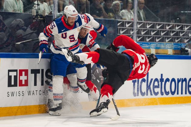FRIBOURG, FRIBOURG - MAY 28: Evan Bouchard of Canada is checked by Ryan Lindgren of the United States during the 2026 IIHF World Championship, WM, Weltmeisterschaft quarterfinal match between Canada and the United States at BCF Arena on May 28, 2026 in Fribourg, Fribourg, Switzerland.  Copyright: xLivioxBaeriswylx xSPPx Sportspressphoto_SPR156126