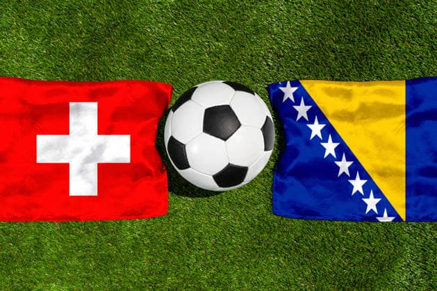 May 22, 2026: PHOTO MONTAGE, 2026 FIFA World Cup, WM, Weltmeisterschaft, Fussball National flags of Switzerland and Bosnia and Herzegovina with a soccer ball on the field. Illustrative image for the group stage match on June 18 at the 2026 FIFA World Cup *** FOTOMONTAGE, Fußball-Weltmeisterschaft 2026: Nationalflaggen von Schweiz und Bosnien Herzegowina mit Fußball auf Rasen. Symbolbild zum WM-Gruppenspiel am 18 Juni bei der FIFA Fussball-Weltmeisterschaft 2026
