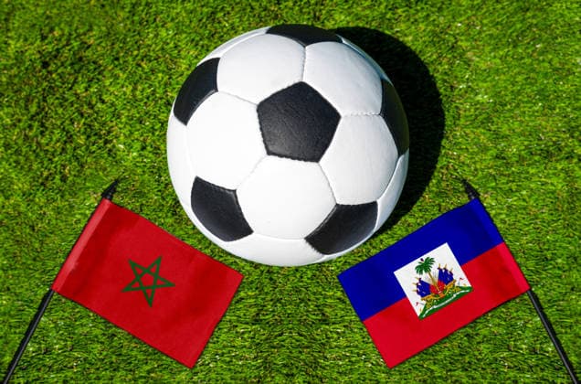 May 22, 2026: PHOTO MONTAGE, 2026 FIFA World Cup, WM, Weltmeisterschaft, Fussball National flags of Morocco and Haiti with a soccer ball on the field. Stock image for the group stage match on June 25 at the 2026 FIFA World Cup *** FOTOMONTAGE, Fußball-Weltmeisterschaft 2026: Nationalflaggen von Marokko und Haiti mit Fußball auf Rasen. Symbolbild zum WM-Gruppenspiel am 25 Juni bei der FIFA Fussball-Weltmeisterschaft 2026
