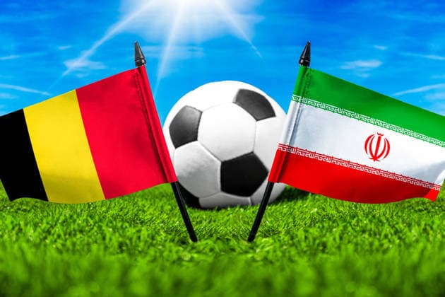 May 22, 2026: PHOTO MONTAGE, 2026 FIFA World Cup, WM, Weltmeisterschaft, Fussball National flags of Belgium and Iran with a soccer ball on the field. Illustrative image for the group stage match on June 21 at the 2026 FIFA World Cup *** FOTOMONTAGE, Fußball-Weltmeisterschaft 2026: Nationalflaggen von Belgien und Iran mit Fußball auf Rasen. Symbolbild zum WM-Gruppenspiel am 21 Juni bei der FIFA Fussball-Weltmeisterschaft 2026