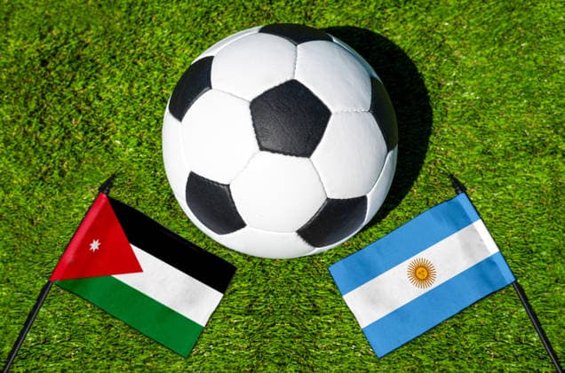 May 22, 2026: PHOTO MONTAGE, 2026 FIFA World Cup, WM, Weltmeisterschaft, Fussball National flags of Jordan and Argentina with a soccer ball on the field. Illustrative image for the group stage match on June 28 at the 2026 FIFA World Cup *** FOTOMONTAGE, Fußball-Weltmeisterschaft 2026: Nationalflaggen von Jordanien und Argentinien mit Fußball auf Rasen. Symbolbild zum WM-Gruppenspiel am 28 Juni bei der FIFA Fussball-Weltmeisterschaft 2026