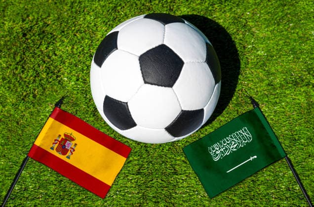 May 22, 2026: PHOTO MONTAGE, 2026 FIFA World Cup, WM, Weltmeisterschaft, Fussball National flags of Spain and Saudi Arabia with a soccer ball on the field. Stock image for the group stage match on June 21 at the 2026 FIFA World Cup *** FOTOMONTAGE, Fußball-Weltmeisterschaft 2026: Nationalflaggen von Spanien und Saudi-Arabien mit Fußball auf Rasen. Symbolbild zum WM-Gruppenspiel am 21 Juni bei der FIFA Fussball-Weltmeisterschaft 2026