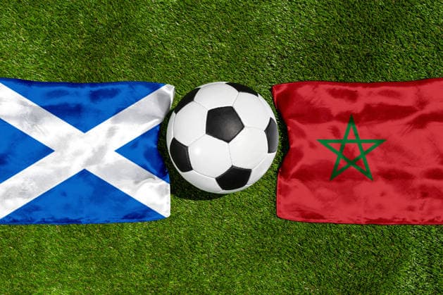 May 22, 2026: PHOTO MONTAGE, 2026 FIFA World Cup, WM, Weltmeisterschaft, Fussball National flags of Scotland and Morocco with a soccer ball on a field. Stock image for the group stage match on June 20 at the 2026 FIFA World Cup *** FOTOMONTAGE, Fußball-Weltmeisterschaft 2026: Nationalflaggen von Schottland und Marokko mit Fußball auf Rasen. Symbolbild zum WM-Gruppenspiel am 20 Juni bei der FIFA Fussball-Weltmeisterschaft 2026