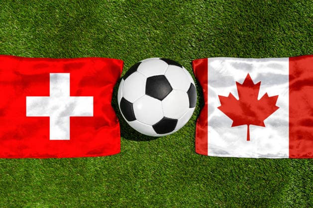 May 22, 2026: PHOTO MONTAGE, 2026 FIFA World Cup, WM, Weltmeisterschaft, Fussball National flags of Switzerland and Canada with a soccer ball on the field. Illustrative image for the group stage match on June 24 at the 2026 FIFA World Cup *** FOTOMONTAGE, Fußball-Weltmeisterschaft 2026: Nationalflaggen von Schweiz und Kanada mit Fußball auf Rasen. Symbolbild zum WM-Gruppenspiel am 24 Juni bei der FIFA Fussball-Weltmeisterschaft 2026