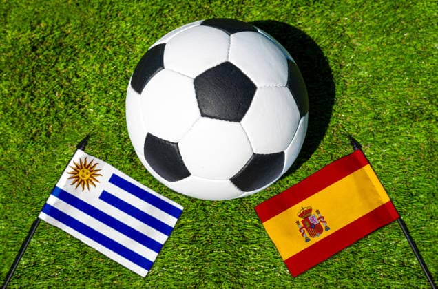 May 22, 2026: PHOTO MONTAGE, 2026 FIFA World Cup, WM, Weltmeisterschaft, Fussball National flags of Uruguay and Spain with a soccer ball on grass. Stock image for the group stage match on June 27 at the 2026 FIFA World Cup *** FOTOMONTAGE, Fußball-Weltmeisterschaft 2026: Nationalflaggen von Uruguay und Spanien mit Fußball auf Rasen. Symbolbild zum WM-Gruppenspiel am 27 Juni bei der FIFA Fussball-Weltmeisterschaft 2026