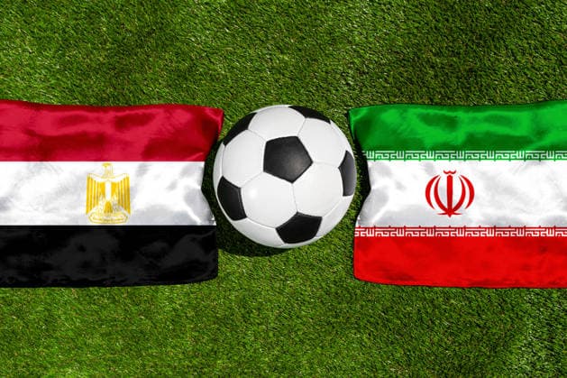 May 22, 2026: PHOTO MONTAGE, 2026 FIFA World Cup, WM, Weltmeisterschaft, Fussball National flags of Egypt and Iran with a soccer ball on the field. Illustrative image for the group stage match on June 27 at the 2026 FIFA World Cup *** FOTOMONTAGE, Fußball-Weltmeisterschaft 2026: Nationalflaggen von Ägypten und Iran mit Fußball auf Rasen. Symbolbild zum WM-Gruppenspiel am 27 Juni bei der FIFA Fussball-Weltmeisterschaft 2026