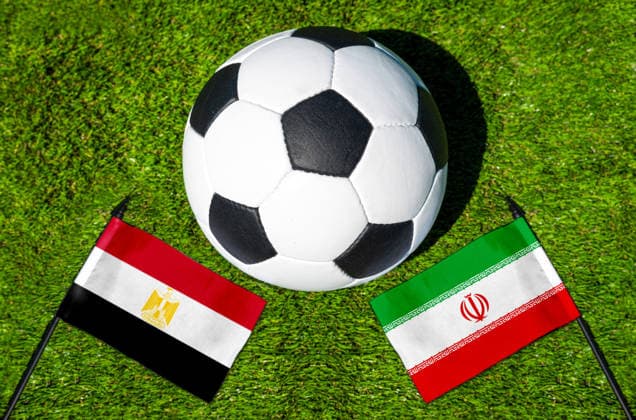 May 22, 2026: PHOTO MONTAGE, 2026 FIFA World Cup, WM, Weltmeisterschaft, Fussball National flags of Egypt and Iran with a soccer ball on the field. Illustrative image for the group stage match on June 27 at the 2026 FIFA World Cup *** FOTOMONTAGE, Fußball-Weltmeisterschaft 2026: Nationalflaggen von Ägypten und Iran mit Fußball auf Rasen. Symbolbild zum WM-Gruppenspiel am 27 Juni bei der FIFA Fussball-Weltmeisterschaft 2026