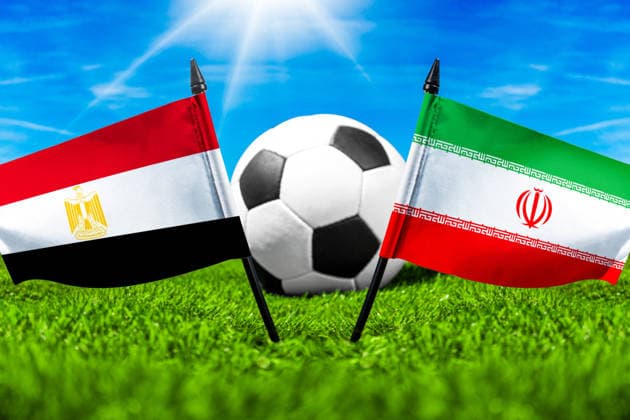 May 22, 2026: PHOTO MONTAGE, 2026 FIFA World Cup, WM, Weltmeisterschaft, Fussball National flags of Egypt and Iran with a soccer ball on the field. Illustrative image for the group stage match on June 27 at the 2026 FIFA World Cup *** FOTOMONTAGE, Fußball-Weltmeisterschaft 2026: Nationalflaggen von Ägypten und Iran mit Fußball auf Rasen. Symbolbild zum WM-Gruppenspiel am 27 Juni bei der FIFA Fussball-Weltmeisterschaft 2026