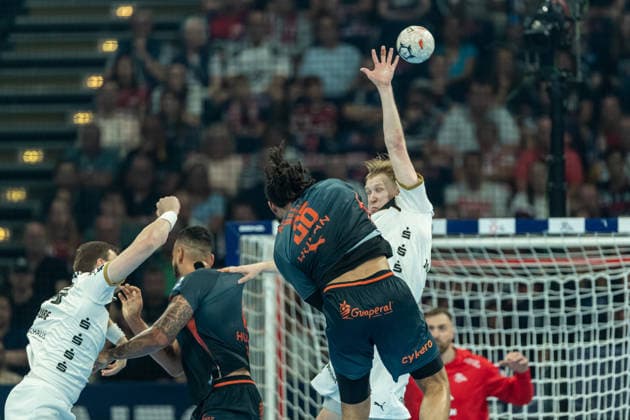 Mathis Becker Fisher Montpellier Handball and Eric Johansson THW Kiel battle for the ball during the handball semi final of the Winamax EHF Finals 2026 between Montpellier Handball and THW Kiel at Barclays Arena on May 30, 2026 in Hamburg, Germany