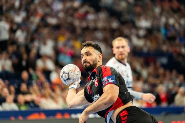 Mohamed Amine Darmoul 71 MT Melsungen takes a shot with the ball in his hand A player of SG Flensburg Handewitt can be seen in the background MT Melsungen vs SG Flensburg Handewitt - EHF Finals Hamburg 2026 Copyright: xPhilippHeistx