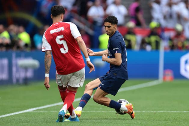 Budapest, Hungary, 30th May 2026. Piero Hincapie of Arsenal FC passes the ball beyond Achraf Hakimi of PSG during the Paris Saint Germain vs Arsenal FC UEFA Champions League Final match at Puskas Arena, Budapest. Picture credit should read: Jonathan Moscrop Sportimage EDITORIAL USE ONLY. No use with unauthorised audio, video, data, fixture lists, club league logos or live services. Online in-match use limited to 120 images, no video emulation. No use in betting, games or single club league player publications. SPI_009_PSG_ARSENAL_UCL SPI-4825-0009