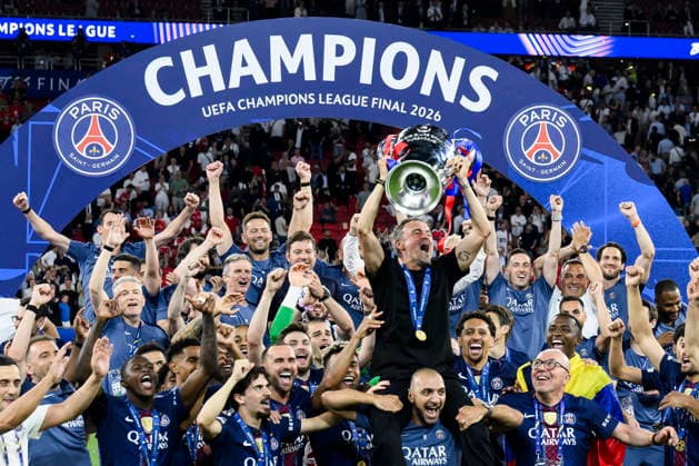 Paris Saint-Germain FC v Arsenal FC - UEFA Champions League Luis Enrique, head coach of Paris Saint-Germain FC, lifts the trophy as Saint-Germain FC players celebrate during the UEFA Champions League 2025 26 final football match between Paris Saint-Germain FC and Arsenal FC. Budapest Hungary Copyright: xNicolòxCampox