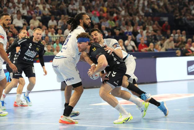photo Goal throw of Johannes Golla Flensburg against Hugo Bryan MONTE dos SANTOS left and Zvonimir SRNA Handball Men on Sun 31 05 2026 Mens EHF European League , Final Four in Hamburg SG Flensburg Montpellier HB Match for 3rd place