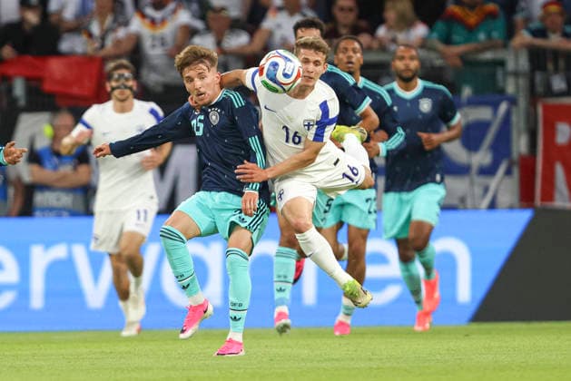 Lennart Karl Germany and Anssi Suhonen Finland battle for the ball during the international friendly match between Germany and Finland at MEWA Arena on May 31, 2026 in Mainz, Germany Photo by Oliver Kaelke DeFodi Images
