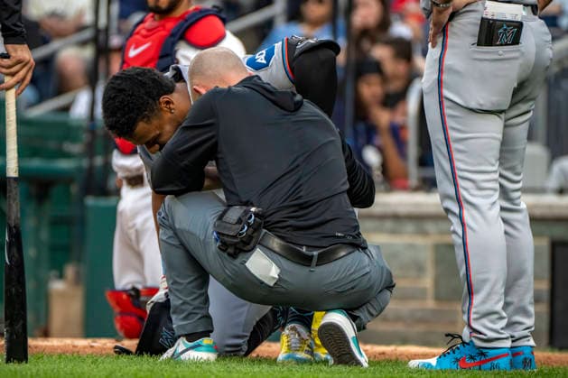 Miami Marlins short-stop Otto Lopez (6) talks to a trainer after being hit with a ball in the top of the second inning during a game against the Washington Nationals at Nationals Park in Washington, DC on Monday, June 1, 2026.  WAP20260601404 BONNIExCASH