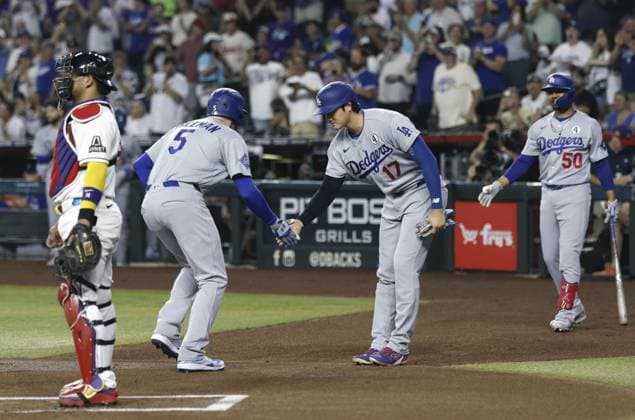 Baseball: Dodgers vs. Diamondbacks Freddie Freeman (5) of Los Angeles Dodgers is greeted by teammate Shohei Ohtani after hitting a two-run home run during the first inning of a baseball game against the Arizona Diamondbacks at Chase Field in Phoenix, Arizona, on June 2, 2026.  A14AA0005617495P