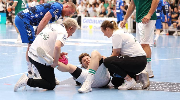 Göppingen Handball Frisch Auf Göppingen vs TVB Stuttgart, Franko Lastro Göppingen, on the ground being treated on the knee, Patrick Zieker TVB, left