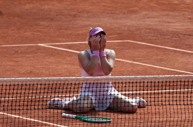 Russian Mirra Andreeva collapses onto the clay after winning her final s match against Polish Maja Chwalinska at the French Tennis Open in Roland Garros in Paris, France, on Saturday, June 6, 2026. Andreeva won 6-3, 6-2.  PAR20260606103 MayaxVIDON-WHITE