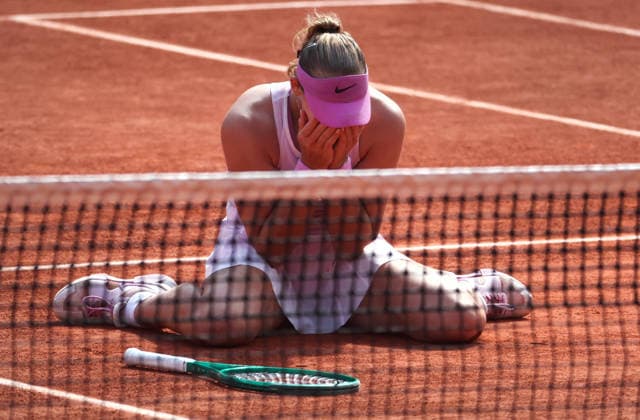 Russian Mirra Andreeva collapses onto the clay after winning her final s match against Polish Maja Chwalinska at the French Tennis Open in Roland Garros in Paris, France, on Saturday, June 6, 2026. Andreeva won 6-3, 6-2.  PAR20260606106 MayaxVIDON-WHITE