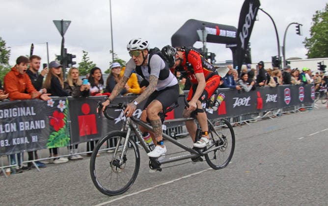 Ironman in Hamburg 2026 Visually impaired Rob Sears h sets off on the bike course with his guide Ant Munson v