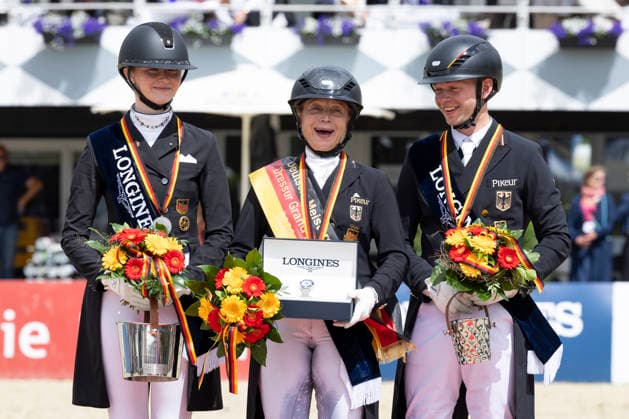 Isabell WERTH GER, mi with Semmieke ROTHENBERGER GER, left , and Raphael NETZ GER, right at the award ceremony, joy, jubilation, laughter, Dressage 03 Longines Grand Optimum Prize, German Championships Grand Prix Kuer 2026, Dressage, Balve Germany, on 07 06 2026 Â