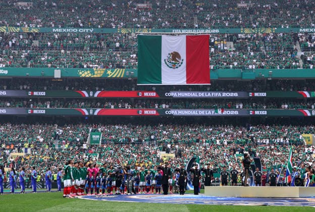 Players stand at midfield as the Mexican national anthem is played before the start of a FIFA World Cup, WM, Weltmeisterschaft, Fussball match against South Africa at Aztec Stadium in Mexico City, Mexico, on Thursday, June 11, 2026.  MEX20260611905 CHRISTIANxBRUNSKILL