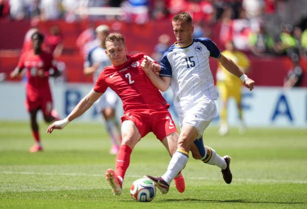 June 12, 2026, Toronto, On, CANADA: Canada s Alistair Johnston (2) and Bosnia-Herzegovina s Amar Memic (15) vie for the ball during the first half of a World Cup Group B soccer match, in Toronto, on Friday, June 12, 2026. Canada News - June 12, 2026  - ZUMAc35_ 20260612_zaf_c35_145 Copyright: xNathanxDenettex